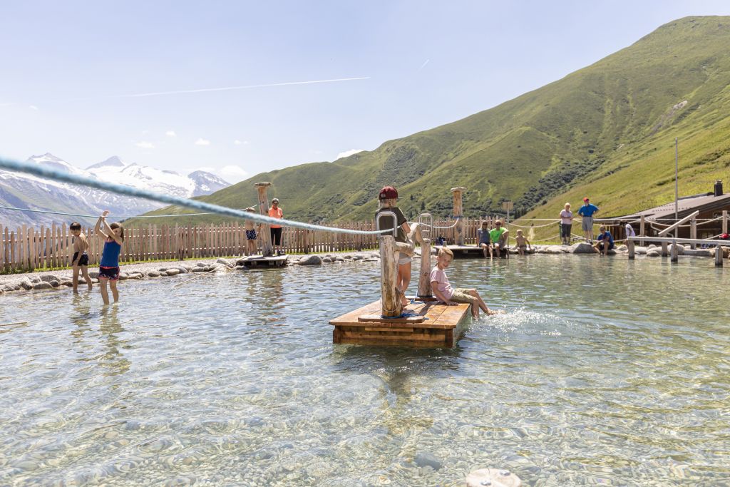 Kinder auf Entdeckungsreise im Wasserteich der Almspielerei Eggalm (TVB Tux-Finkenberg)