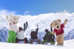 Familie hat Spaß beim Rodeln mit Maskottchen (c)Wildkogel - Arena Neukirchen &amp; Bramberg